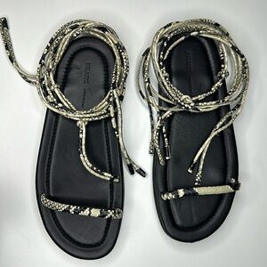 KHAITE Black Leather Lace-Up Sandals with Snake-Print Straps